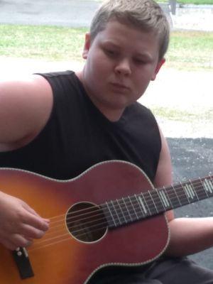 Playing his new guitar for his grandparents.