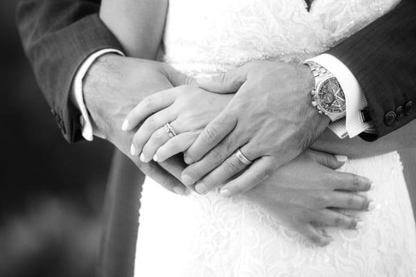 Detail shot of bride and groom's hands with rings