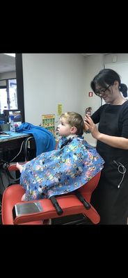 My son at 1 year old getting his hair cut by Miss Emily.