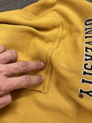 Pointing at double stitch done to fix issue on heavy weight sweatshirt.