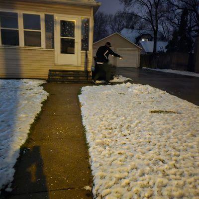 Working hard clearing out customers driveway and sidewalks