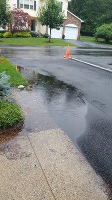 Water puddled up on new driveway by Dow Asphalt and Pavers.