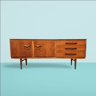 Beautility UK vintage concave front teak credenza with ring pulls.