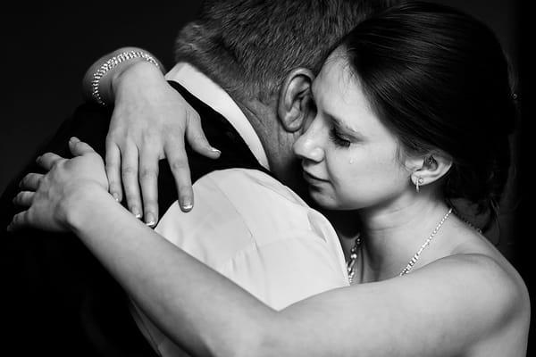 Bride cries as she dances with her father on her wedding day.