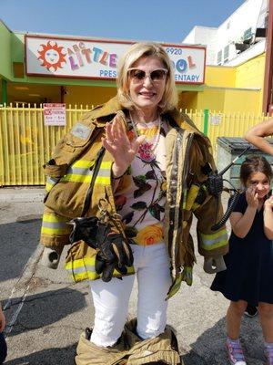 Director and founder of ABC Little School... Miss Roza, tries on the heavy work gear of our brave firefighters! "Whewwww, it's so heavy!"