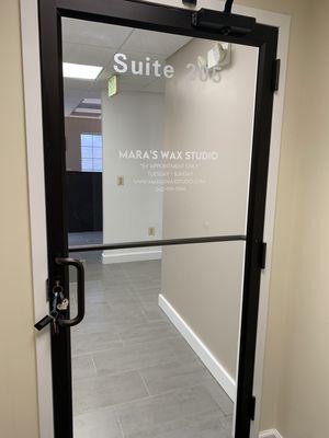 Mara's Wax Studio Suite door #205 located on the second floor inside Crofton Woods Shopping Center.