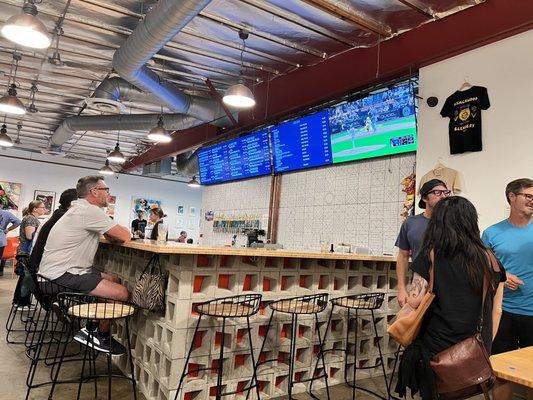 Front bar view from corner - list of beers & TV