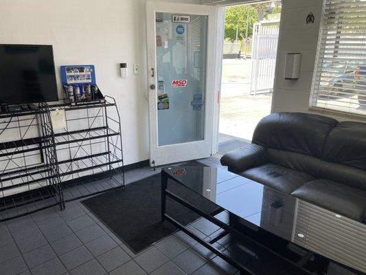 Customer waiting area with hand sanitizer and free masks