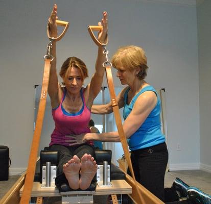 Mary Bange working with client on the reformer.