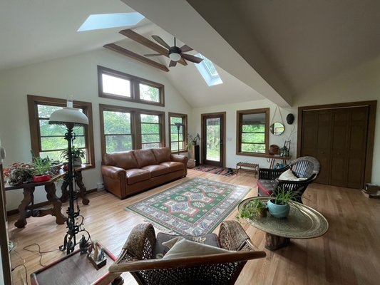 Expanded living room with a cathedral ceiling, skylights and with the relocation of the front door.