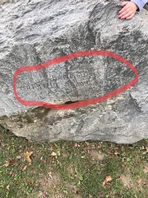 I marked up this photo to see the engraving on the rock which is located at the entrance. It's very difficult to see just passing by.