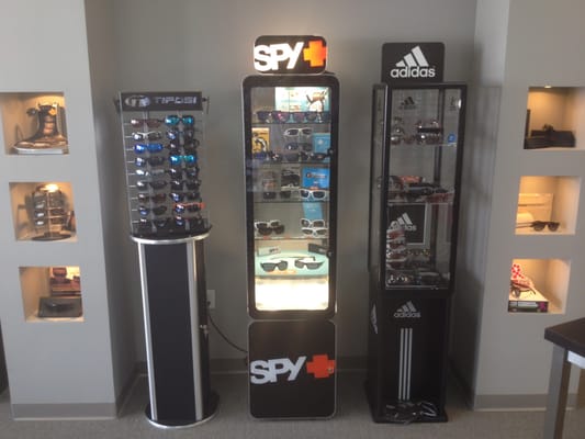 Carrying over 100+ Brands. Tifosi, Spy Optics & Adidas displays in this photo.