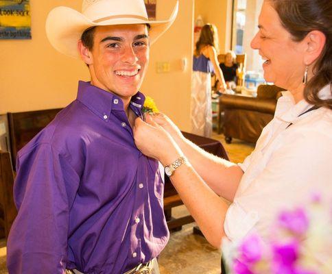 Getting the boutonniere pinned on that cowboy,