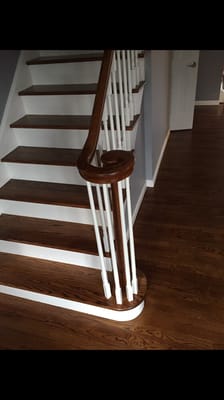 Dark stain steps against the white risers and spindals