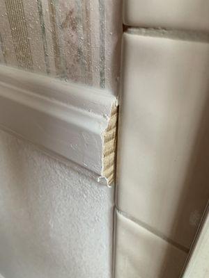 This chair molding runs to the shower plus4 inches of tile. Moisture will easily get into unpainted wood.