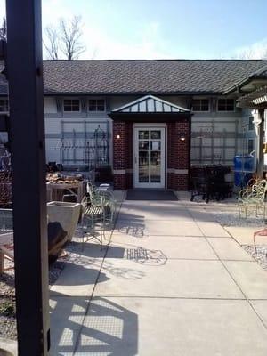 Entrance to greenhouse and gift shop. Perennials located outdoor on patio under pergola. Wonderful selections.