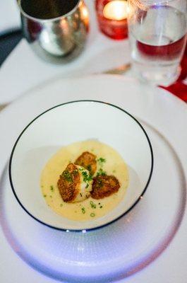 Seared scallops with a garlic cream sauce.