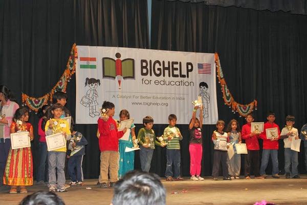 Children receiving certificates and tropies for winning constests.