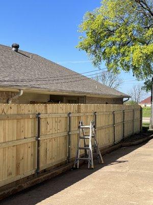 Straightened out crooked fence top per customer request after the fence guy rebuilt the fence.