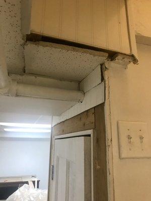 poorly hung door, unfinished wall and ceiling