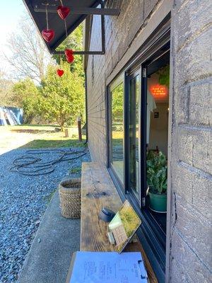 Walk up window on the left side of the building decorated for Valentine's Day!