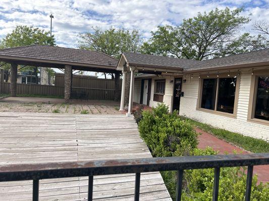 Dilapidated patio and odd wooden stage