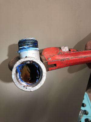 Elbow full of rust leaking rust into our clean water supply because they couldn't be bothered to buy the correct part