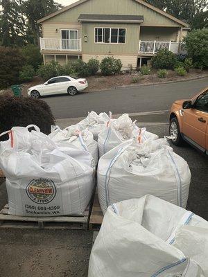 7 super-sacs, neatly stacked leaving room to enter and exit the garage and driveway