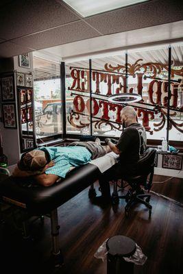 Mike with Red Letter Tattoo working on a customer.