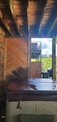 Water dripping from top deck onto the  lukewarm hot tub