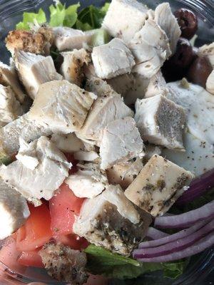 Delicious salad with grilled chicken on top.