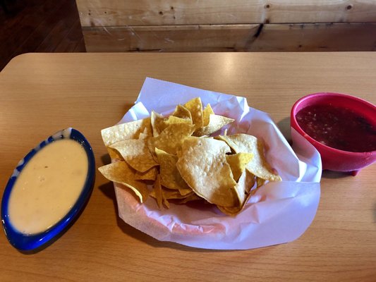 Chips with salsa and yellow cheese dip