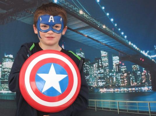 Superheroes against photo backdrop of NYC skyline