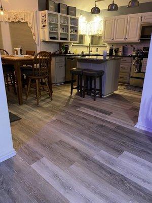 Flooring extends directly into the kitchen, and makes the rooms look larger!