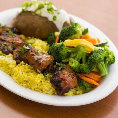 Steak Skewer plate on a bed of rice with choice of 2 sides.