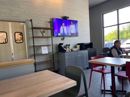 TV but nobody is paying attention, area to fix your coffee if you didn't request it when you ordered and pickup area for DoorDash.