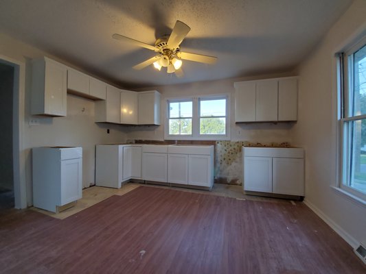 Installed cabinets with crown in rental property.