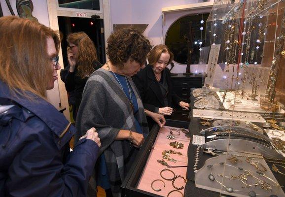 Customers shop Thomas Mann's jewelry collection at Gallery I/O.