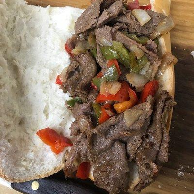 Steak onions and peppers on fresh Cuban bread