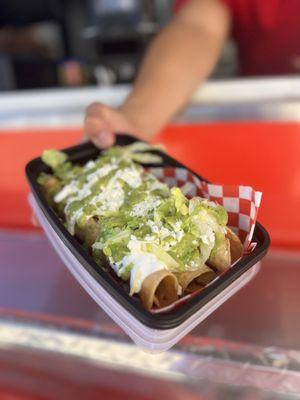 Chicken and cheese taquito with green salsa