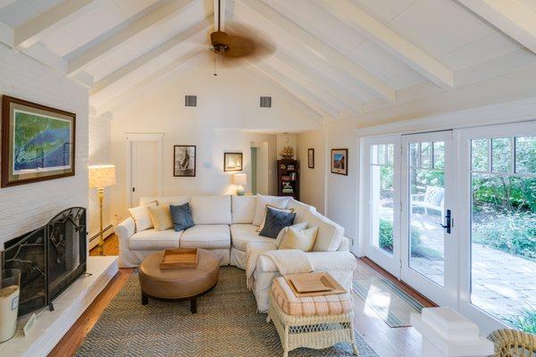 Custom built living room with a lot of natural light, furnished.