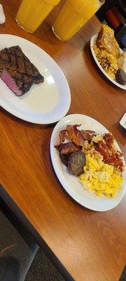 Steak, eggs, bacon, sausage, potatoes and French toast