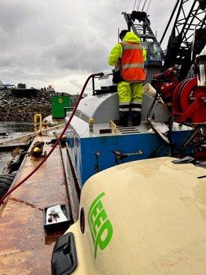 Transferring fuel from the Remote supplier to construction equipment on the neighboring island of Gravina