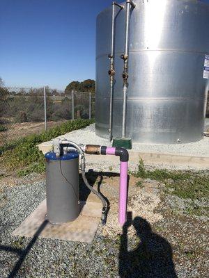 Multiple Storage Tank Installation with booster pump, pressure tank, and VFD well pump/motor.