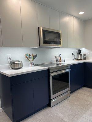 Modern Kitchen Complete Remodel. Beautiful custom cabinets finished with cool white uppers and navy lowers.