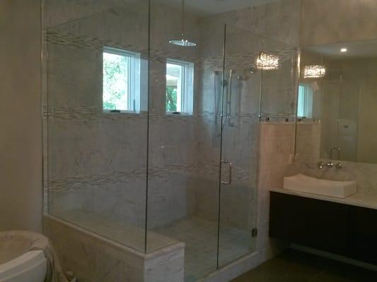 Frameless shower enclosure