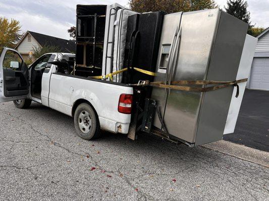 Pickup of a couple refrigerators and shelving