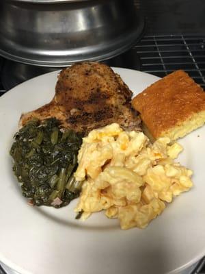 Grilled pork chops, homemade macaroni and cheese, mustard greens and cornbread.