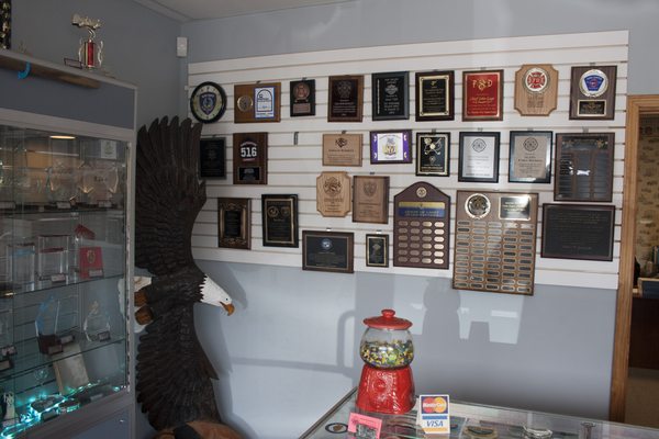 Inside our showroom, with various samples of awards we offer.