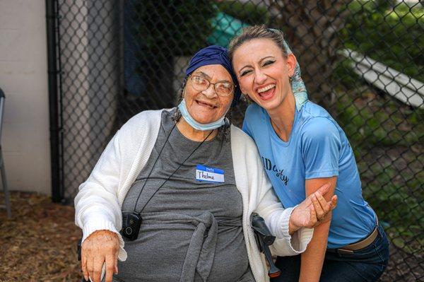 An IDignity team member and client laugh while waiting for her identification documents.